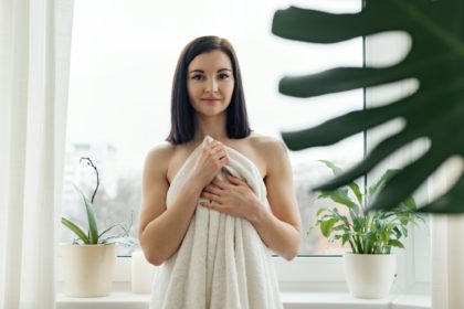 Beauty portrait of young brunette woman in bath towel, spa at home