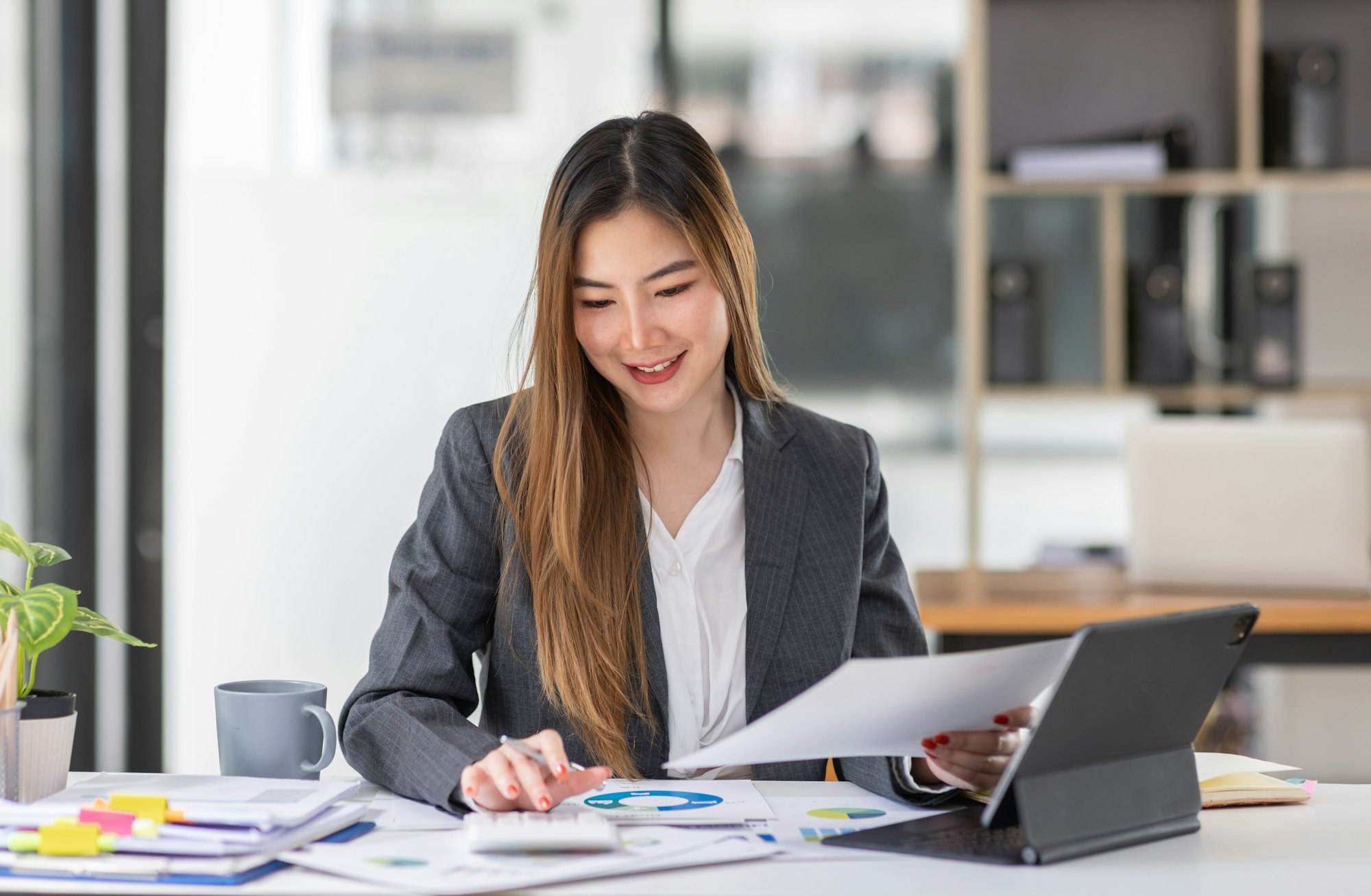 Businesswoman or accountant working Financial investment on calculator, calculate, analyze business