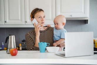 Mother balancing between work and baby on sick or maternity leave.