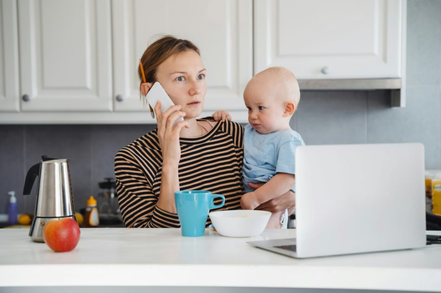 Mother balancing between work and baby on sick or maternity leave.