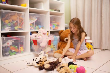 Toys galore. Shot of a young girl playing with toys in a room.